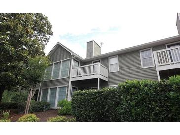Side view of a home with siding, white trim, and a deck at 704 Olde Mill Ln, Norcross, GA 30093