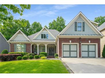 Charming single-Gathering home with a well-manicured lawn and two-car garage at 1290 Magnolia Park Cir, Cumming, GA 30040