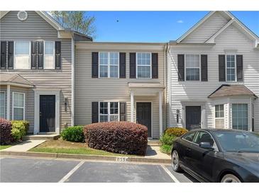 Attractive townhome featuring a well-maintained front yard and convenient parking at 6554 Arbor Gate Sw Dr # 4, Mableton, GA 30126