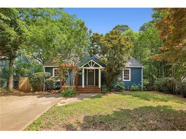 Charming blue home with a well-maintained lawn and mature trees at 1592 Braeburn Se Dr, Atlanta, GA 30316