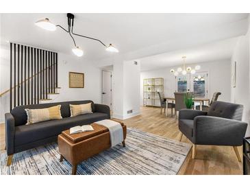 Bright living room featuring modern lighting, hardwood floors and a comfortable sofa and decor at 126 Marona Ne St, Atlanta, GA 30307
