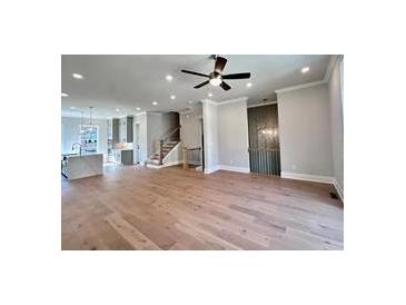 Spacious living room features hardwood floors and modern ceiling fan at 285 Briscoe Way # 2, Alpharetta, GA 30009