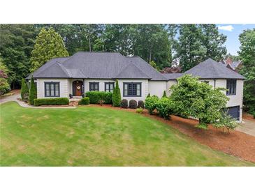 Stunning home with lush landscaping, dark trim, and manicured lawn creates excellent curb appeal at 4030 River Ridge Se, Marietta, GA 30067