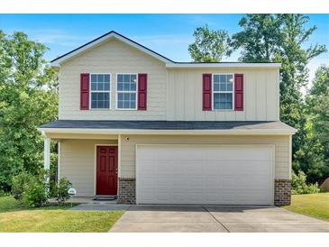 Charming two-story home featuring red shutters, a covered porch, and an attached two-car garage at 3 Windsor Ct, Kingston, GA 30145
