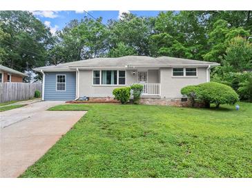 Charming single-story home featuring a lush green lawn, mature trees, and a welcoming front porch at 2756 Gresham Se Rd, Atlanta, GA 30316