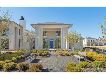 Stunning home with blue front door, a garden, and well-manicured landscaping at 260 Guild Ln, Fayetteville, GA 30214