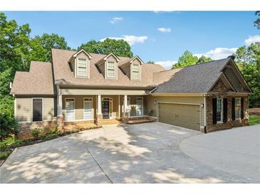 Charming exterior elevation showcasing the home's craftsman design and well-manicured landscaping at 148 Copper Hills Dr, Canton, GA 30114