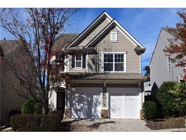 Charming two-story home with a two-car garage and neutral siding, surrounded by lush landscaping at 2955 Briaroak Dr, Duluth, GA 30096