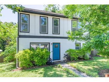 Charming two-story home featuring a bright blue front door and lush landscaping at 2405 Hillside Ave, Decatur, GA 30032