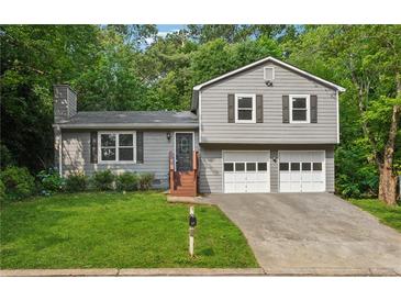 Charming two-story home with a well-manicured lawn and a two-car garage at 3919 Valley Brook Rd, Snellville, GA 30039