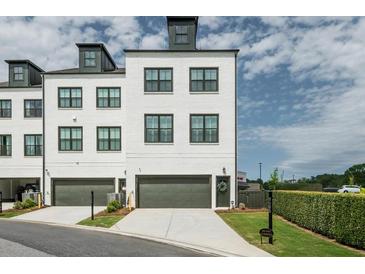 Contemporary townhome with painted brick, 1-car garage and manicured landscaping at 6895 Whitman Walk, Alpharetta, GA 30005