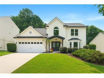 Charming two-story home with manicured lawn, black trim, arched window, and a two-car garage at 3684 Clearbrooke Way, Duluth, GA 30097