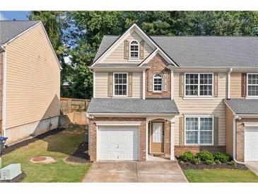 Charming two-story home with a one car garage and a well maintained lawn at 4161 Magnolia Glen Walk, Norcross, GA 30093