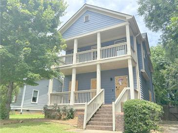 Charming two-story home with a spacious porch on both floors, offering ample outdoor living space at 1539 Beecher Sw St, Atlanta, GA 30310