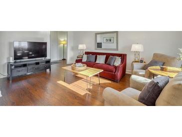 Cozy living room featuring hardwood floors, comfortable seating, and a modern entertainment center at 215 Piedmont Ne Ave # 1406, Atlanta, GA 30308