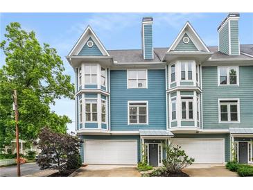 Charming townhome featuring bay windows, a two-car garage, and inviting curb appeal at 1912 Hosea L Williams Ne Dr # 1, Atlanta, GA 30317