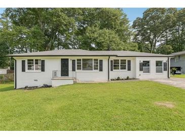 Charming exterior of a freshly painted brick home with black shutters and a well-manicured lawn at 1261 Cliffwood Se Dr, Smyrna, GA 30080
