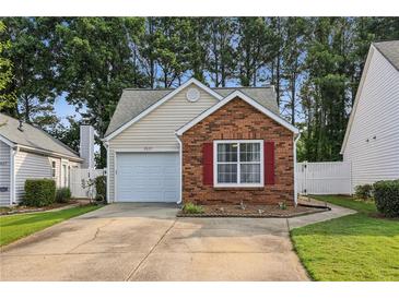 Charming single-story home featuring a brick facade, attached garage, and well-maintained landscaping at 2657 Albion Farm Way, Duluth, GA 30097