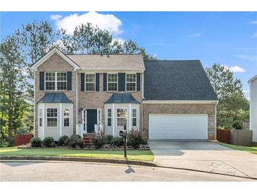 Charming two-story home with a brick facade, well-maintained lawn, and a two-car garage at 3943 Alexandra Oak Ct, Suwanee, GA 30024