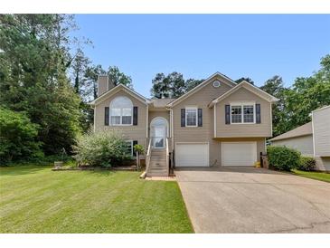 Charming two-story home with a well-maintained lawn, two-car garage and inviting front porch at 503 Silver Maple Ln, Woodstock, GA 30189