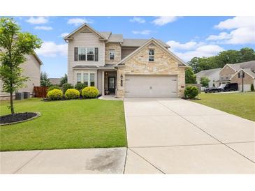 Charming two-story home with stone accents, well-manicured lawn, and a two-car garage at 1998 Lakeview Bend Way, Buford, GA 30519