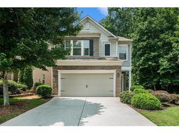Charming two-story home featuring a stone facade and a well-maintained front yard with lush landscaping at 85 Brushed Ives Ct, Lawrenceville, GA 30045
