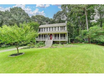 Charming two-story home with a welcoming front porch and a well-manicured lawn with mature landscaping at 2816 Highland Park Dr, Stone Mountain, GA 30087