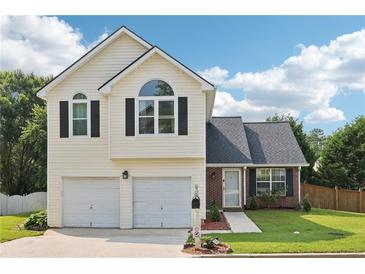 Charming two-story home with a two-car garage and well-maintained front yard at 7033 Brecken Trce, Lithonia, GA 30058