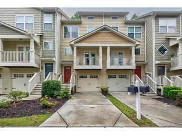 Inviting townhouse exteriors with private garages, balconies, and well-maintained landscaping at 1293 Liberty Nw Pkwy, Atlanta, GA 30318