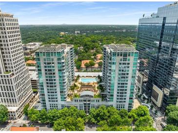 Stunning aerial view of luxury high-rise condos with a pool and beautiful green surroundings at 943 Peachtree Ne St # 2001, Atlanta, GA 30309