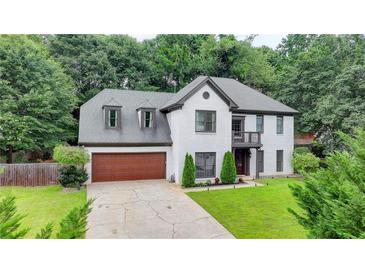 Charming white brick home with a well-manicured lawn and attached two-car garage at 3085 Saint Andrews Dr, Duluth, GA 30096