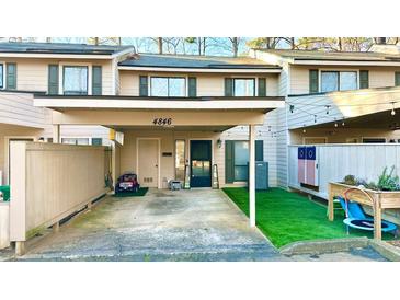 Townhome exterior with covered parking and lovely landscaping features at 4846 Twin Lakes Trl, Atlanta, GA 30360