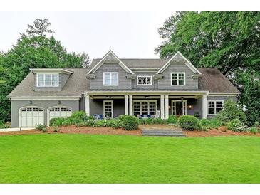Charming gray home featuring a large front yard, covered porch, and a two-car garage at 1178 Chambord Ne Way, Brookhaven, GA 30319