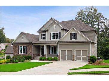 Charming two-story home featuring a well-manicured lawn, neutral siding, stone accents and a two-car garage at 147 Longleaf Dr, Canton, GA 30114