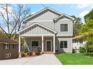 Charming two-story home with gray siding, white trim, inviting front porch, and a well-manicured front yard at 1521 Sylvan Sw Rd, Atlanta, GA 30310