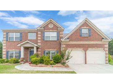 Charming two-story brick home with a two-car garage and well-manicured landscaping at , Loganville, GA 30052