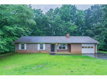 Charming single-story home featuring a brick and vinyl exterior with a well-maintained front yard at 604 Hamlet Se Ct, Conyers, GA 30094