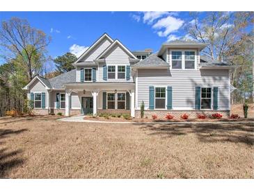 Charming two-story home with a manicured lawn and traditional architecture, perfect for Gathering living at 165 West Lake Blvd, Carrollton, GA 30116