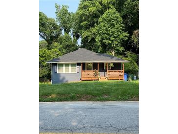 Charming single-story home features a welcoming front porch and a well-manicured lawn at 2319 Beecher Sw Rd, Atlanta, GA 30311