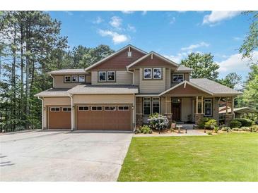 Charming two-story home with a manicured lawn, a two-car garage, and beautiful landscaping at 1268 Harris Road Rd, Lawrenceville, GA 30043