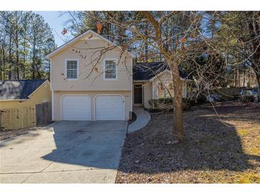 Charming two-story home features a two-car garage and well-maintained lawn at 2105 Sandtree Sw Ct, Atlanta, GA 30331