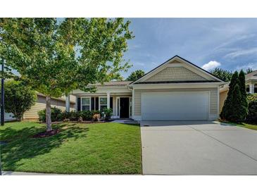 Charming single-story home with a well-manicured lawn, inviting curb appeal, and a two-car garage at 110 Baltusrol Way, Covington, GA 30014