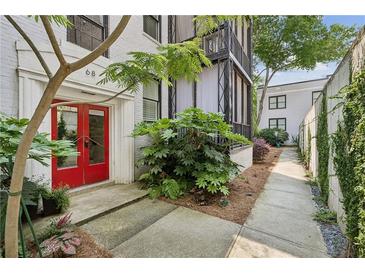 Charming building entrance with a red front door and landscaped walkway at 68 Peachtree Memorial Nw Dr # 68-1, Atlanta, GA 30309