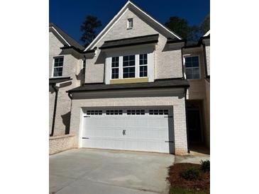 Charming two-story home with a white brick exterior, a two-car garage, and a neatly manicured lawn at 4160 Cavalier Way, Duluth, GA 30097