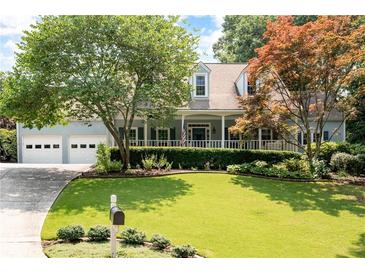Charming home with a large, well-manicured lawn and lush landscaping at 2915 Preakness Nw Dr, Marietta, GA 30064