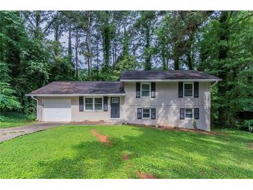 Charming split-level home with a well-maintained lawn and an attached garage at 1539 Pine Glen Cir, Decatur, GA 30035