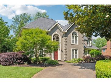 Charming two-story home with a well-manicured front yard and inviting curb appeal at 11880 Wexford Club Dr, Roswell, GA 30075