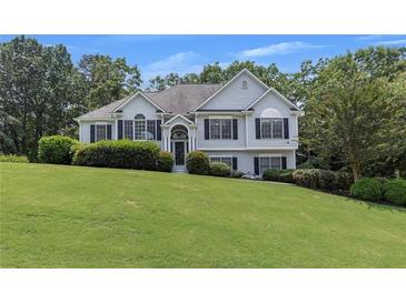 Charming two-story home with manicured lawn and traditional architectural details at 100 Chestnut Hill Dr, Canton, GA 30114
