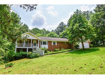 Charming single-Gathering home with a brick facade, inviting front porch, and a lush green lawn at 3223 Heritage Way, Buford, GA 30519
