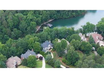 Stunning aerial view of lakefront homes surrounded by lush greenery and a private dock at 1515 Lockridge Dr, Cumming, GA 30041